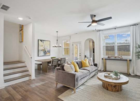 Spacious living area with easy access to the stairwell and upper levels.