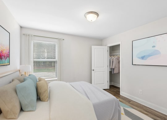 a bedroom with a bed and a door to a closet