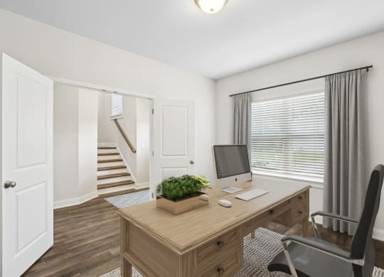 a home office with a desktop computer on a wooden desk