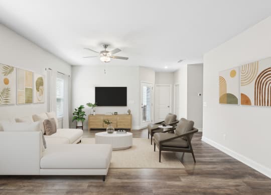 a living room with white furniture and a ceiling fan