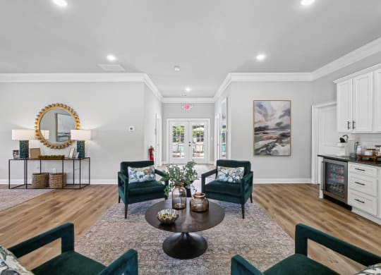 a living room with chairs and a table