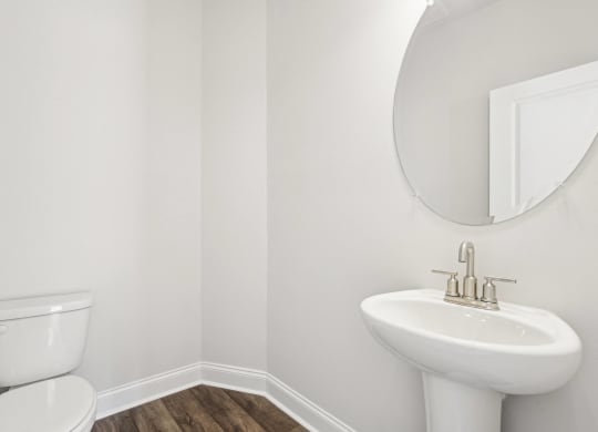 a bathroom with a toilet and a sink and a mirror