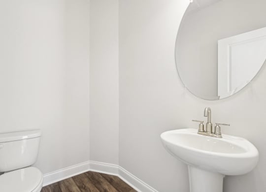 a bathroom with a toilet and a sink and a mirror