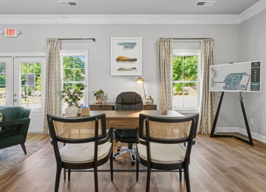 a dining room with a table and chairs and a easel in a room with