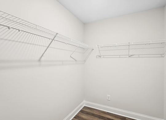 an empty closet in a room with white walls and wood flooring