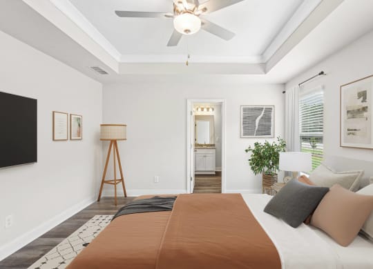 a bedroom with a large bed and a ceiling fan