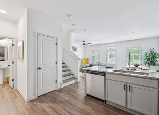 Spacious living area with easy access to the stairwell and upper levels.
