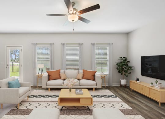 a living room with a couch and a ceiling fan