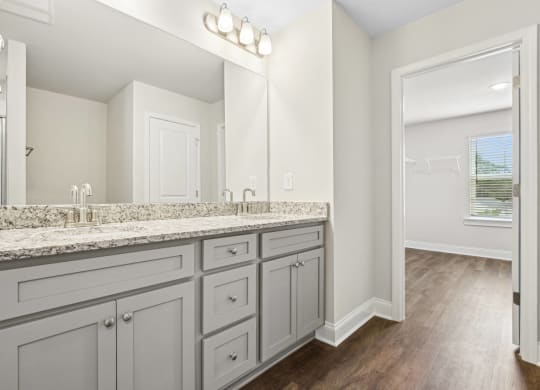 a white bathroom with a large mirror and a large sink