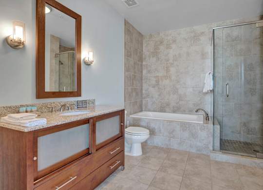A bathroom with a toilet, sink, and shower.