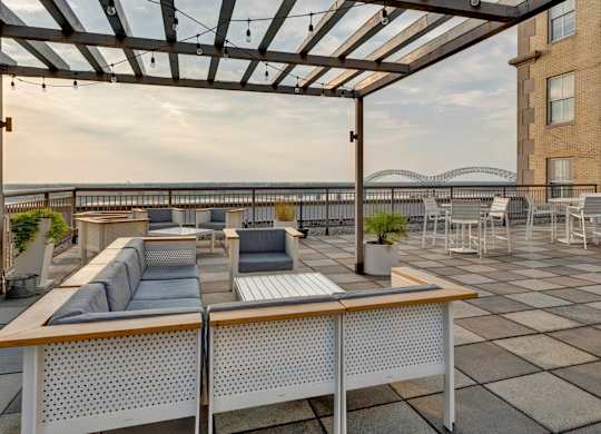 a rooftop terrace with couches and tables and a glass roof at Metro67, TN, 38103