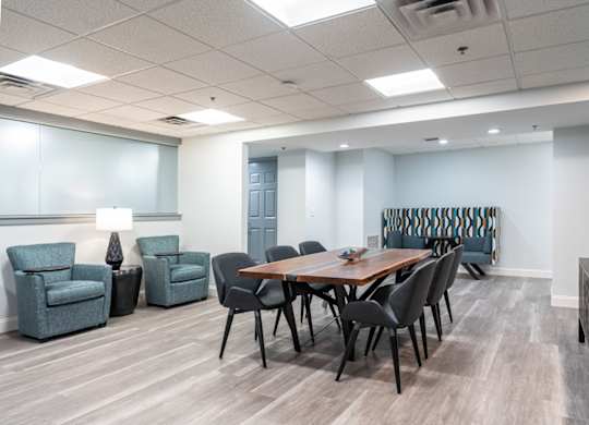 a meeting room with a table and chairs