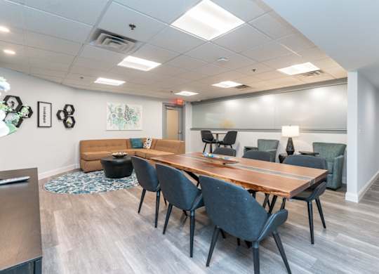 a conference room with a wooden table and chairs