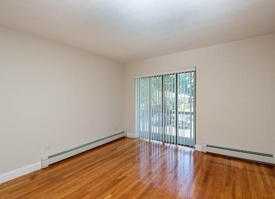 Quincy Commons one bedroom apartment with wood flooring and balcony