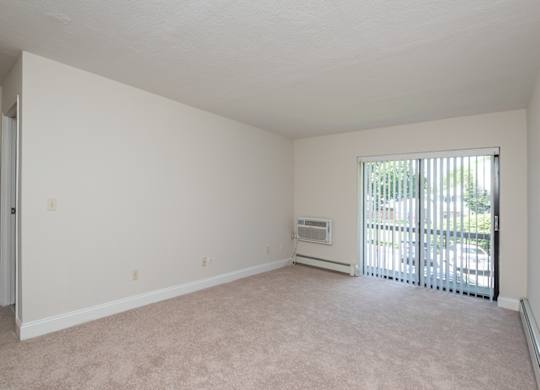 Quincy Commons one bedroom apartment with plush carpeting and balcony