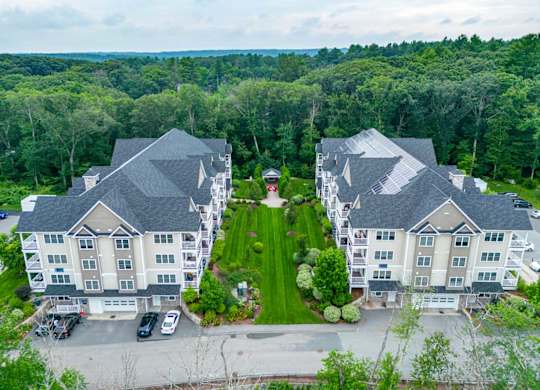 Aerial view of Ashland Woods, grilling station and apartment buildings with lush forest in background
