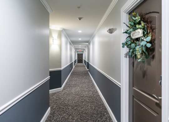 a long hallway with a bouquet of flowers on the door