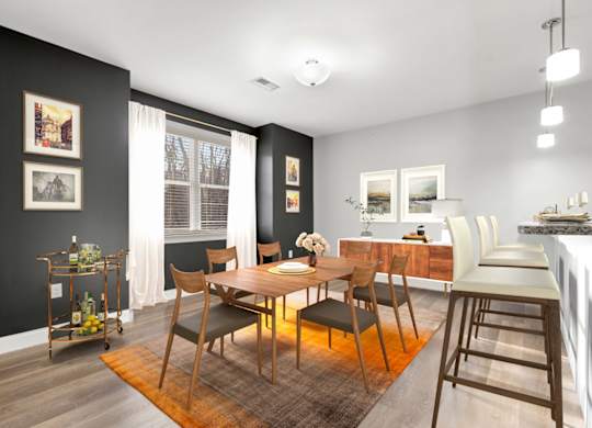 Ashland woods apartments in MA dining area with accent wall and vinyl flooring, virtually staged