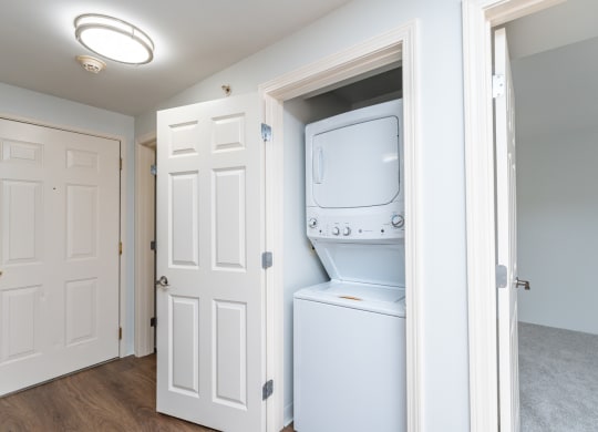an empty laundry room with a washer and dryer