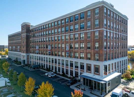 an aerial view of a large brick building on a city street