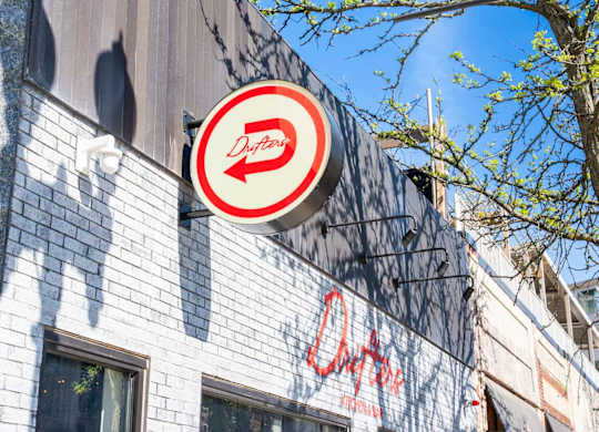 Drifters restuarant sign is on a building.