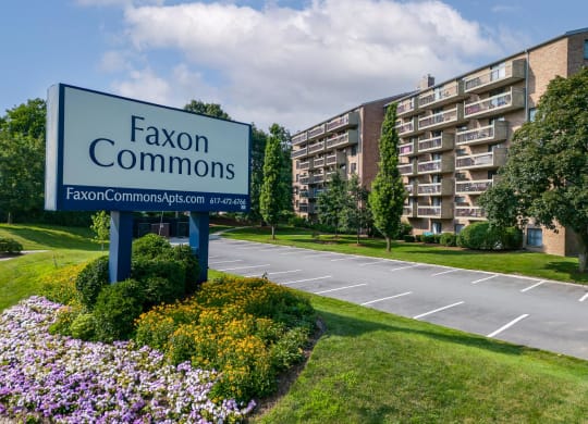 a sign that says faxon commons in front of a building