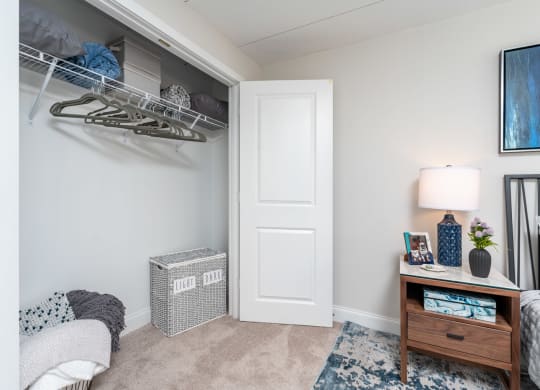 a bedroom with a closet and a desk with a lamp