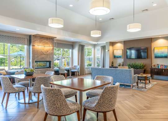 a living room with tables and chairs and a fireplace