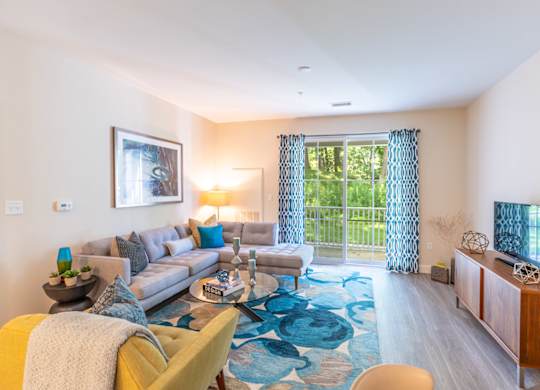 a living room with a couch and a tv and a sliding glass door