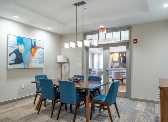 a dining room with blue chairs and a wooden table
