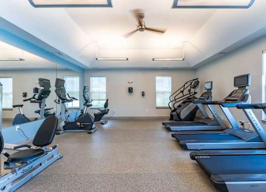 the gym with treadmills and ellipticals at the belmont shores apartments