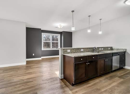 Ashland woods apartment large floor plan and kitchen including granite, stainless steel appliances and high quality finishes with accent wall