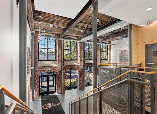 A view of a staircase with a black mat on the floor that says "COMMUNITY".