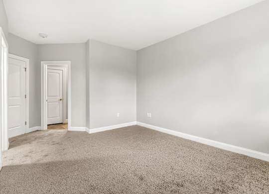 Ashland woods apartments in MA bedroom with carpet flooring and large windows
