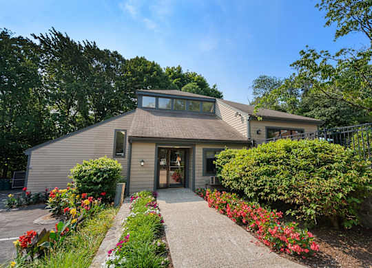 A house with a grey roof and a brown front door.