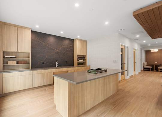 A modern kitchen with wooden cabinets and a central island.