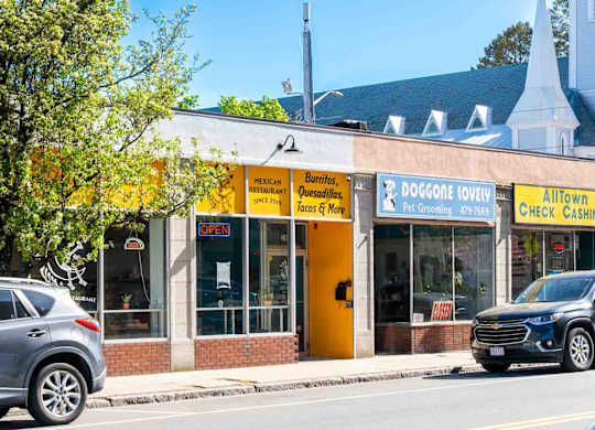 A yellow and white building with a sign that says