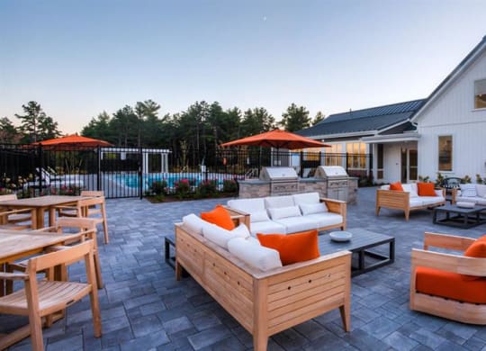 Redbrook leasing center, pool area, outdoor seating, grills and fire pit.