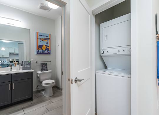 A white oven is in a kitchen next to a toilet at the Mastlight.
