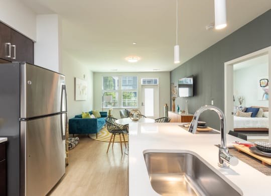 kitchen and living room at the district flats apartments in lenexa, ks