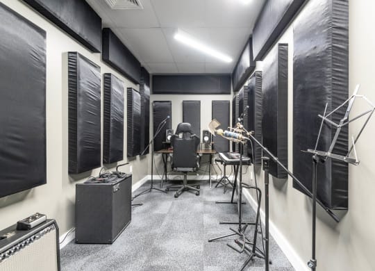 a recording studio with a variety of instruments and microphones