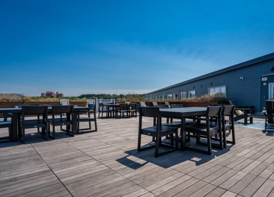 a patio with tables and chairs on a roof