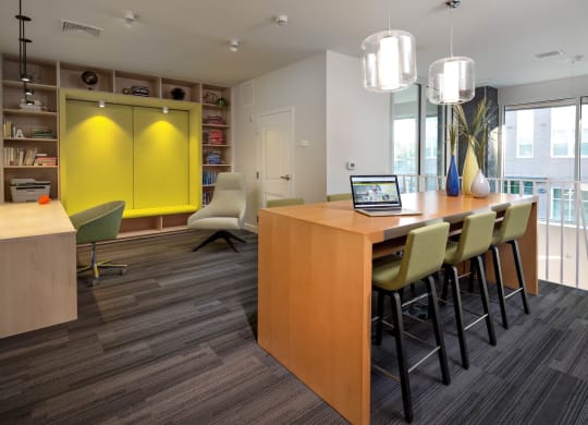 a room with a table and chairs with a laptop on it