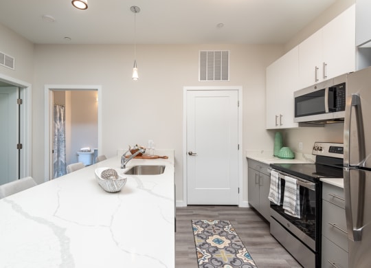 Millside kitchen granite countertops stainless appliances oven range microwave bright finishes