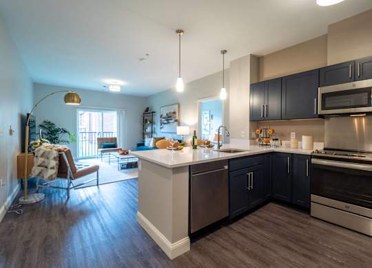 Another angle of a spacious kitchen showcasing an open layout with views into the living and dining areas.