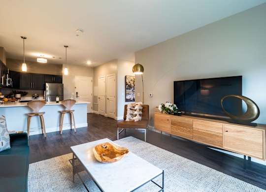 A contemporary living area with a stylish layout, featuring a modern couch, a chic coffee table, and elegant lighting.