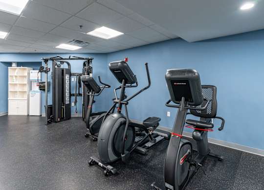 a group of exercise bikes in a room