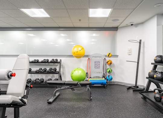 a fitness room with weights and other exercise equipment
