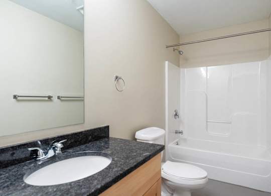 A bathroom with a sink, toilet and bathtub.