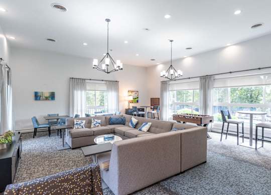 a living room with a couch and a table with chairs